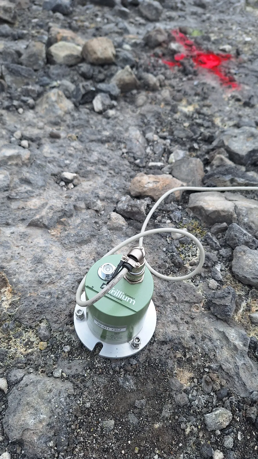 A seismic instrument on the volcanic ground.