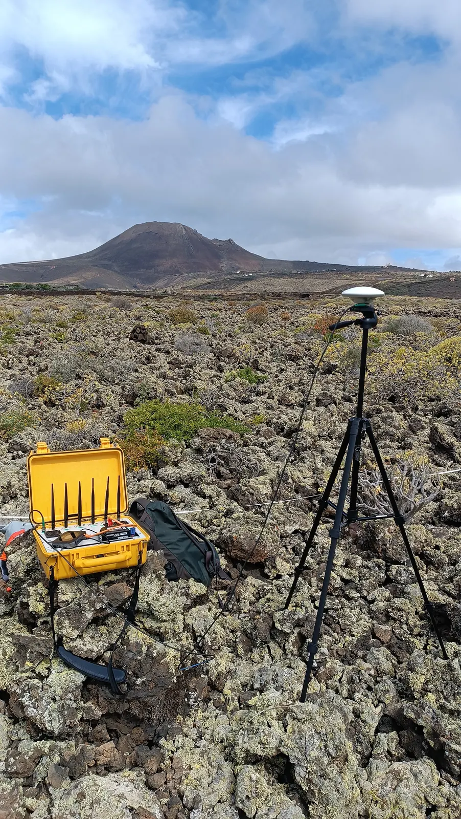 Field equipment with the volcanic landscape beyond.